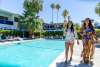 Couple women walking by the pool at Holiday House.