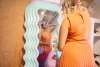 Women shopping at mirror.