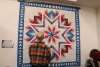 A man admiring a quilt at Monroe County's America250PA kick-off event