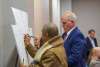 Women and man sign the keystone in support of Monroe County's America250PA initiative