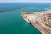 An aerial view of a port on Lake Michigan. A large ship is docked.
