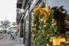 Holiday wreath with gold ribbons hanging on a reflective window
