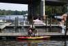 Two people on a boardwalk getting ready to get into a kayak