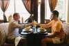 Two people sitting at a table having a meal