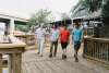 Four men walking along a boardwalk