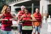 A group of people putting on life jackets
