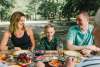 A family sitting together at a picnic table