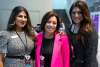 3 women professionals at conference