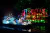 Night parade with river barge decorated with Dia de los Muertos decor