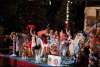 Group of people waving on holiday themed float