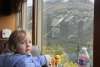 Lucy, age 2, enjoys a train ride with her mom to see her dad, the conductor