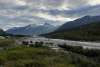 Sun shining through the mountains onto a much smaller Skagway River in early September