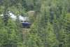 White Pass Train going through mountain with steam