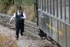 The conductor on the White Pass Rail running to catch up to the train after retrieving a cell phone from the tracks dropped by a passenger on a previous train. He made it too!