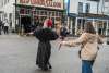 Madame Trixie Turner leads a street walking class to the red Onion on Broadway.
