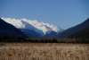 Michael Gil: Snow covered mountains rise above the open flatlands of Dyea, in the quiet of April.