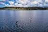 two paddle boarders on a lake
