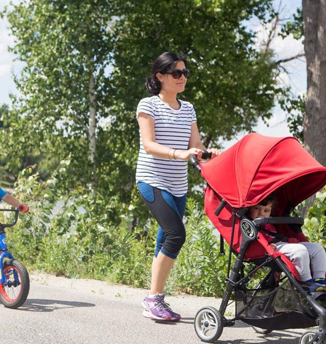 Family walking near the Fox River on the trail in De Pere