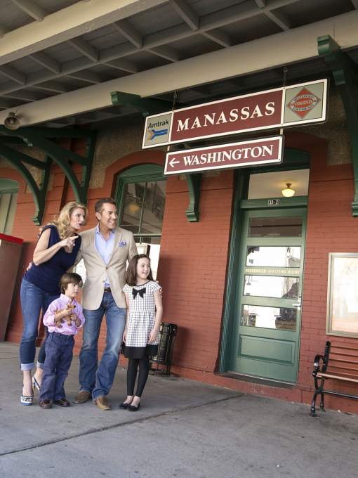 A family standing outside of a train station
