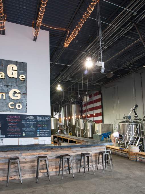 A bartender behind the bar at heritage brewing co