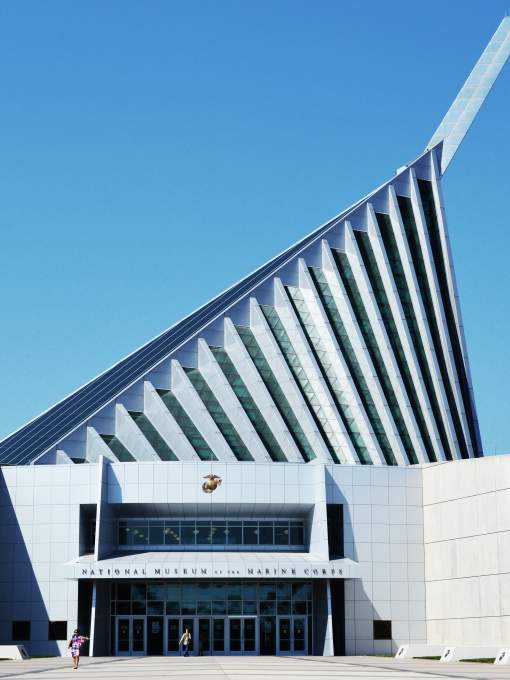 A white building with an off-center triangle roof
