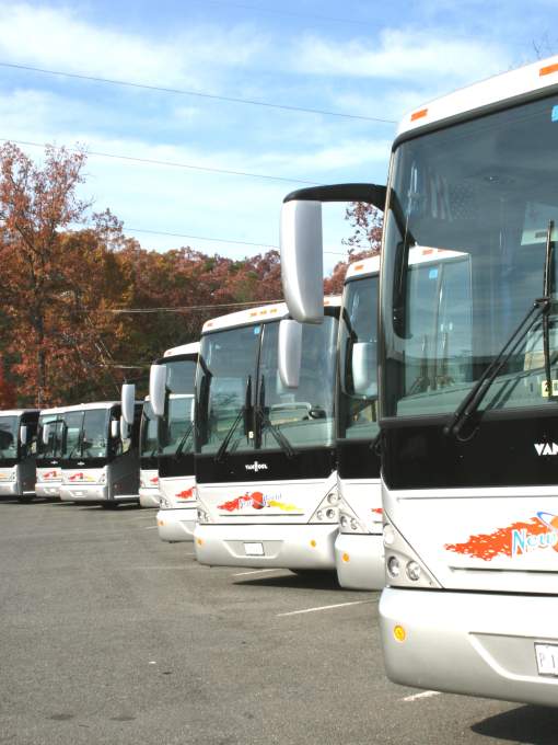 Motor coaches lined up in a parking lot