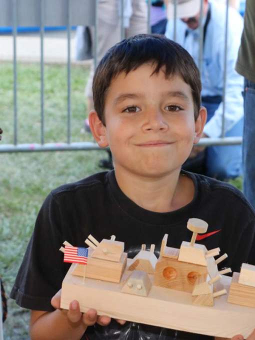 Child At Boat Shop at Wooden Boat Festival in Madisonville