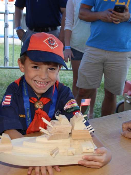 Child Making Toy Wooden Boat at The Wooden Boat Festival in Madisonville