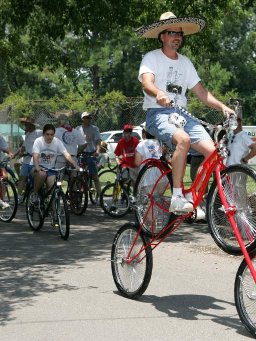 Man Riding 2 Bicycles at Once at Louisiana Bicycle Festival in Abita Springs