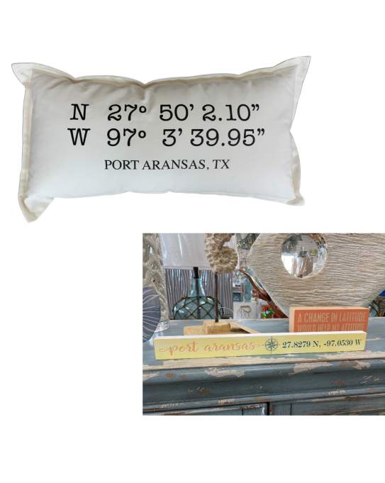 A pillow and a sign with coordinates on a white background