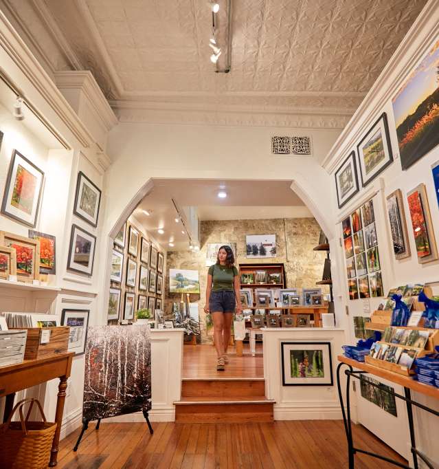 Person walking through an art gallery.