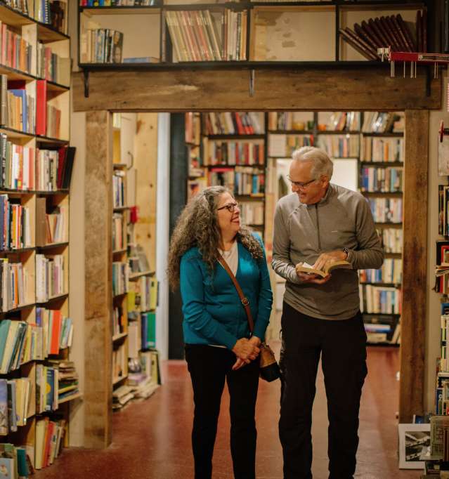 Couple reading book in antique store