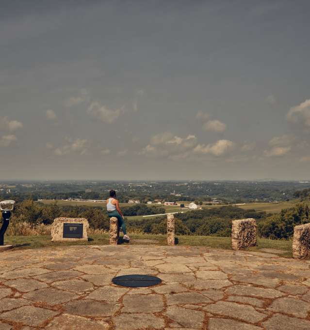 Person at an overlook, looking out into the valleys.