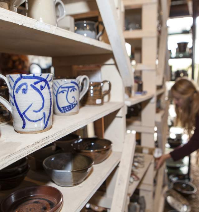 A person shopping for pottery