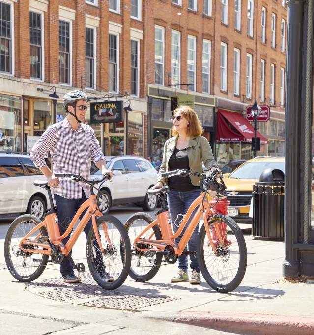 Couple cycling on Galena's Main Street