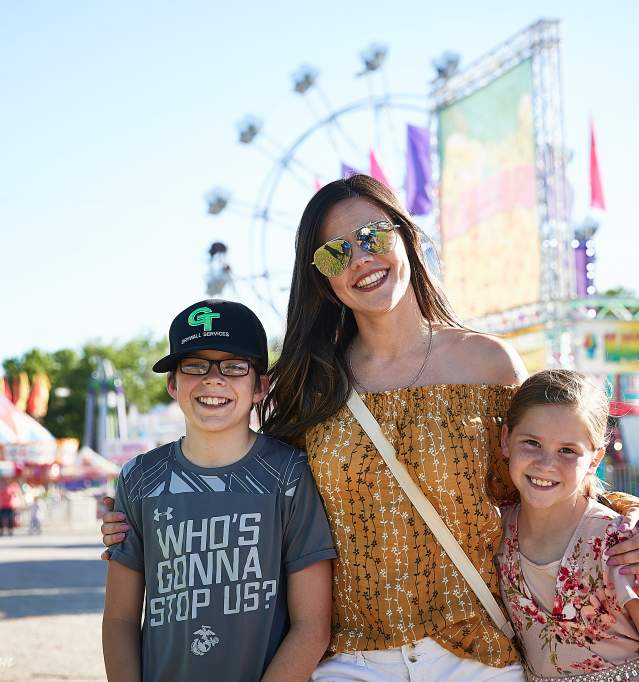 Family in front of Ferris Wheel