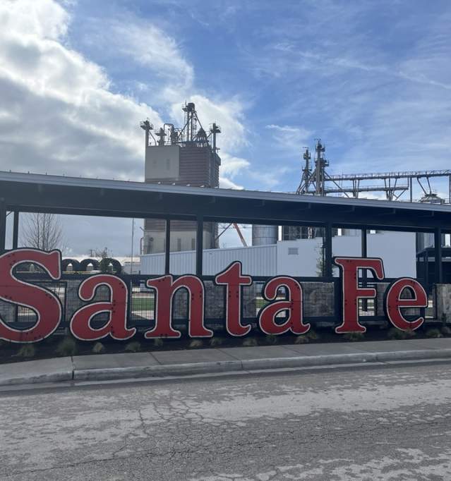 Photo depicts the sign at the Santa Fe Community Market that says "Santa Fe" in bold red typeface.