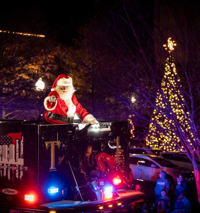 Santa on float with Christmas Tree in background