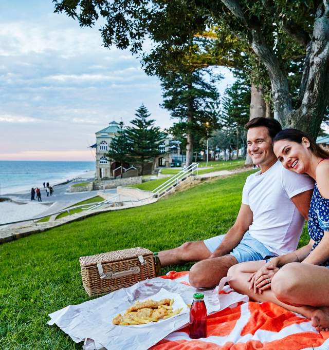 Couple sitting at Cottesloe Beach