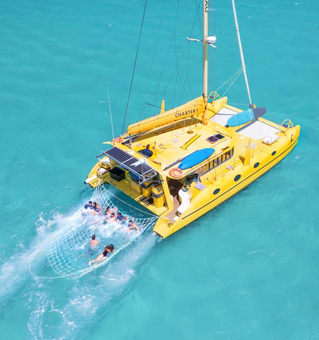 Bright yellow yatch in turquiose water