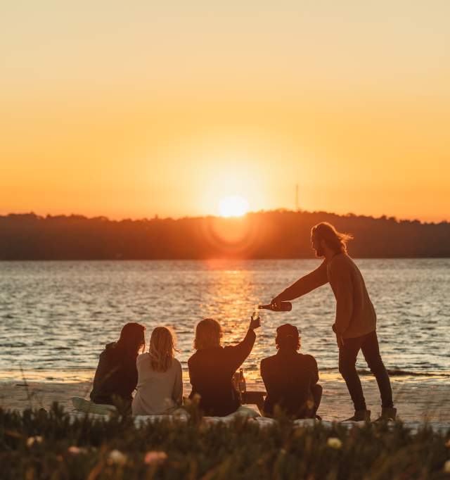Group enjoying sunset over a lake in Dwellingup