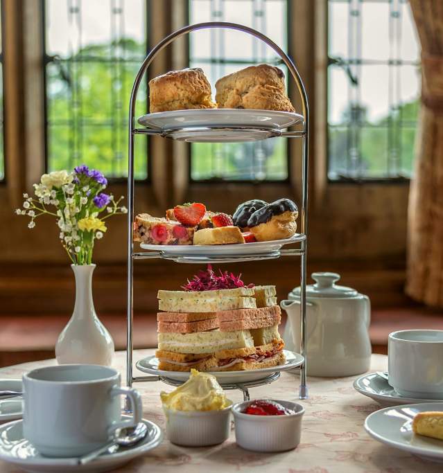 an afternoon tea display on a table with bay window in background