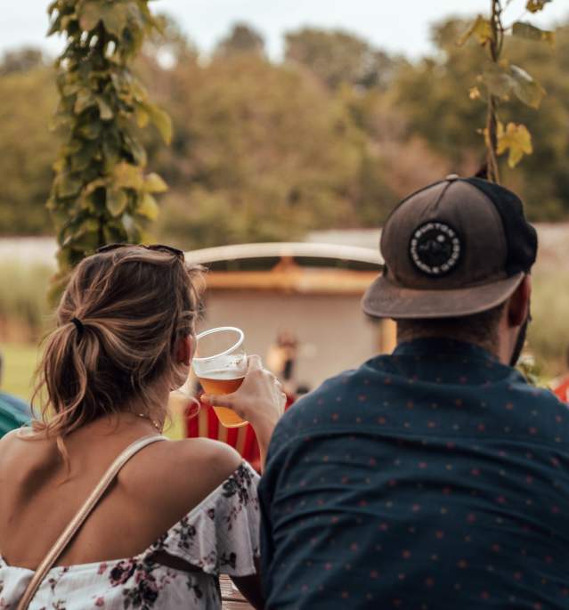 Back of woman and man drinking beer