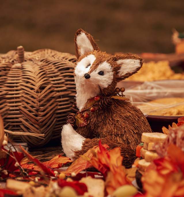 Wicker fox on table with autum items