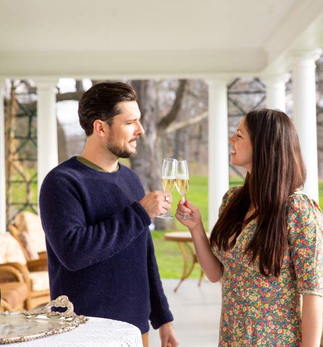Man and woman drinking champagne on outdoor porch
