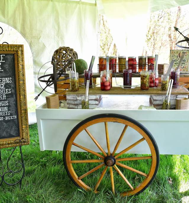Pickle bar display with signage and jars on cart