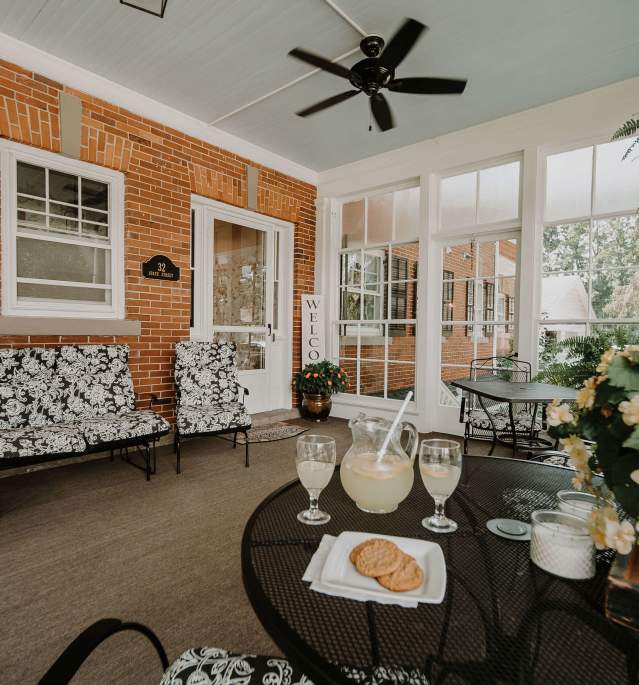 Screened in porch with table and chairs