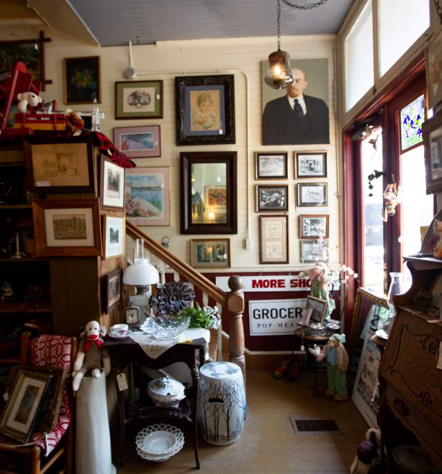 Antique items displayed in store by stairs