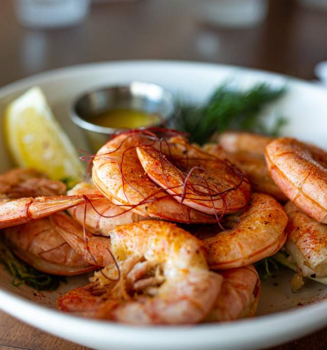 Plate with seasoned shrimp and garnish