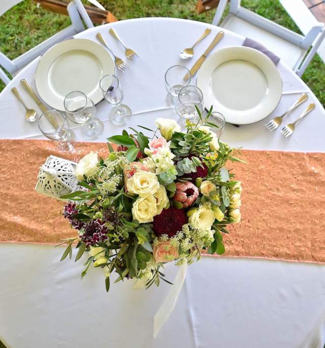 Floral arrangement on decorated table with two chairs